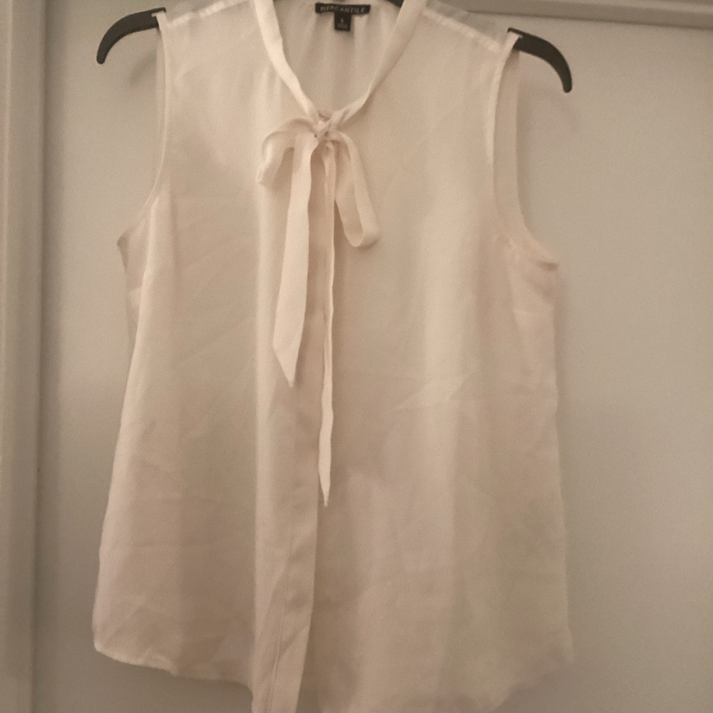 Cream color sleevless blouse with a neck tie